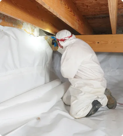 Acculevel 9 A person in protective clothing inspects a space under a wooden beam, surrounded by white sheeting, holding a flashlight.